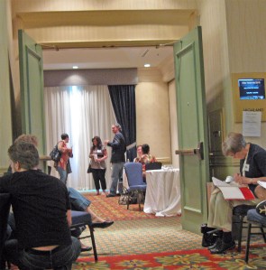 Agents Jill Marr (left) and Cari Foulk standing for a few moments after listening to pitches.