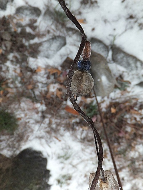Ice encrusted plastic beads on a metal wire.