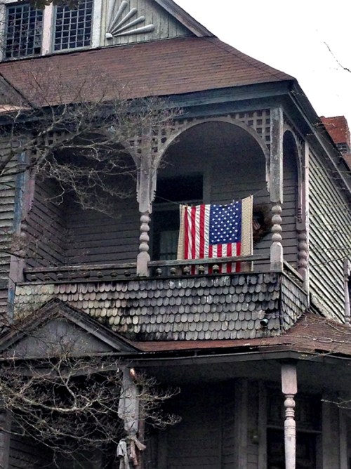 An old house; a new flag. The problems and the promises run deep.